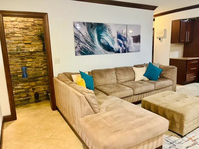 a living room with furniture and painting on the wall