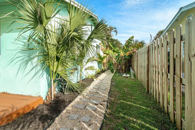 a view of a house with a backyard porch and sitting area