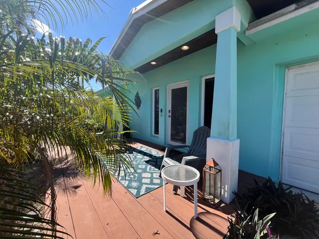 a backyard of a house with outdoor seating