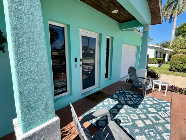 a backyard of a house with outdoor seating