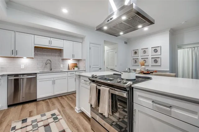 a kitchen with stainless steel appliances granite countertop a stove and a refrigerator