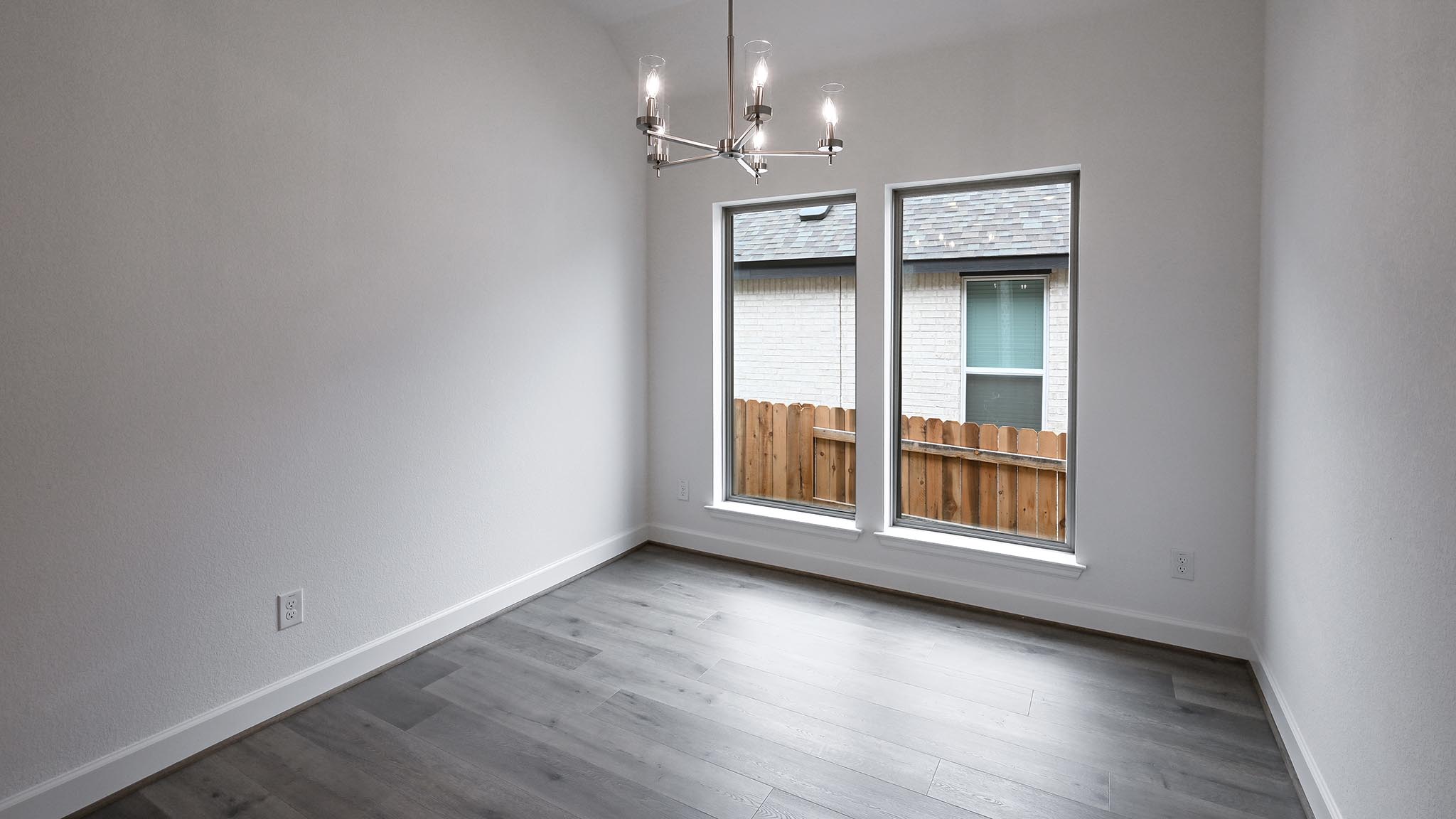 268 Basket Flower Loop Kyle, TX 78640 - Photo 21 of 27 a view of an empty room with a window and wooden floor