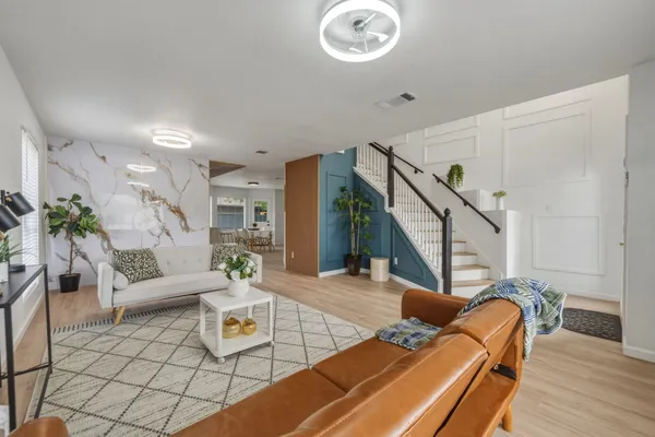 a living room with furniture and wooden floor
