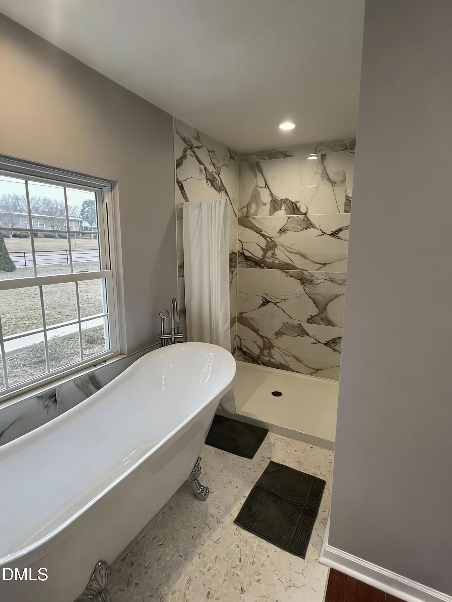 409 Rockingham Street Carthage, NC 28327 - Photo 31 of 56 a bathroom with a bathtub and shower