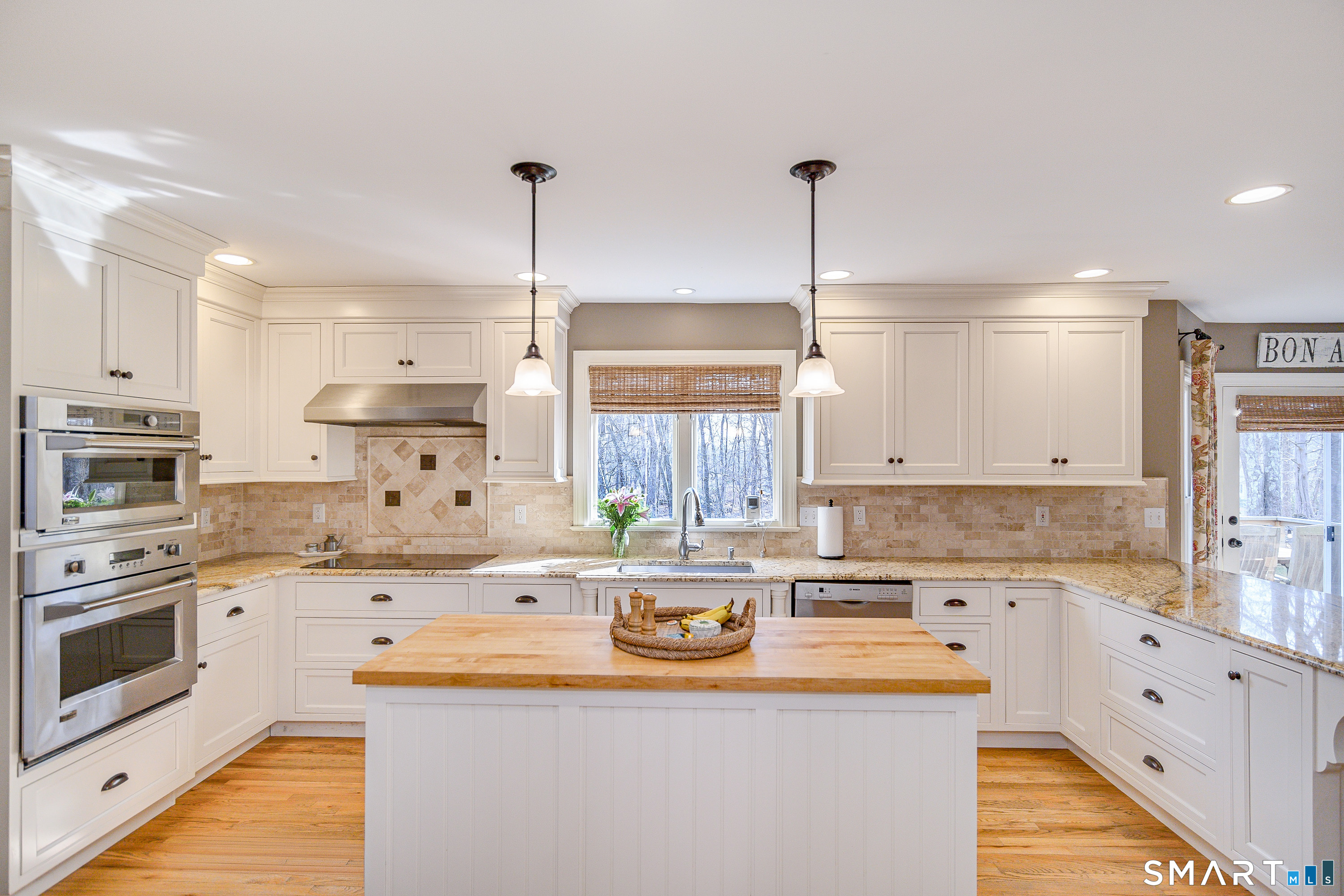 20 Charter Ridge Drive Newtown, CT 06482 - Photo 12 of 40 The kitchen features an island with butcher block top and convection wall oven and microwave.