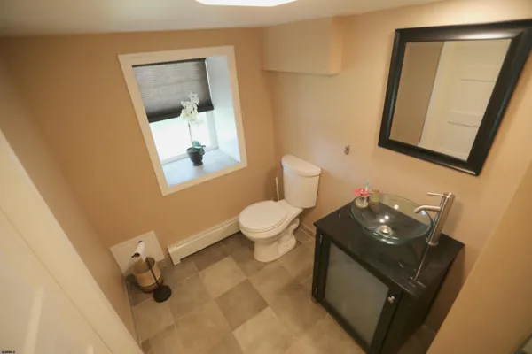 a bathroom with a sink toilet and mirror