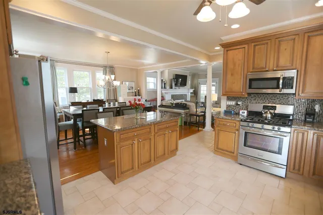 a kitchen with stainless steel appliances granite countertop a refrigerator and a sink