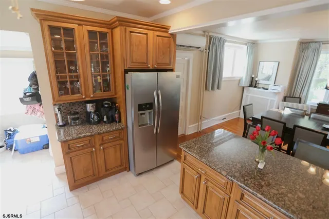 a bathroom with a stove a sink and a mirror