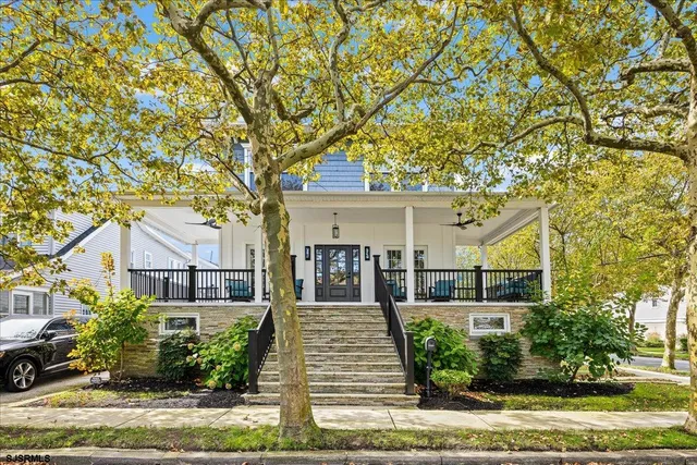 front view of a house with a tree in front