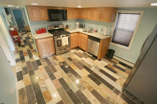 a kitchen with a sink stove and refrigerator