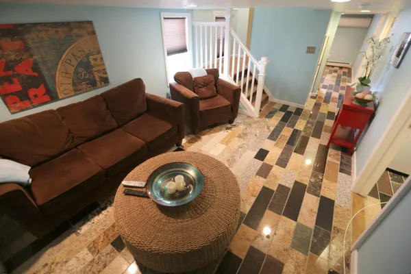 a living room with furniture and a mirror