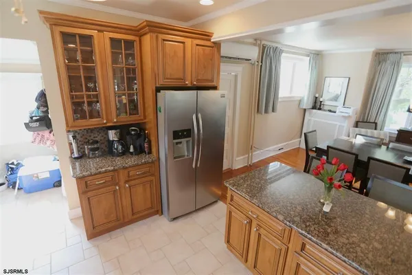 a kitchen with stainless steel appliances granite countertop a refrigerator and a sink