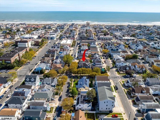an aerial view of a house with a garden and lake view