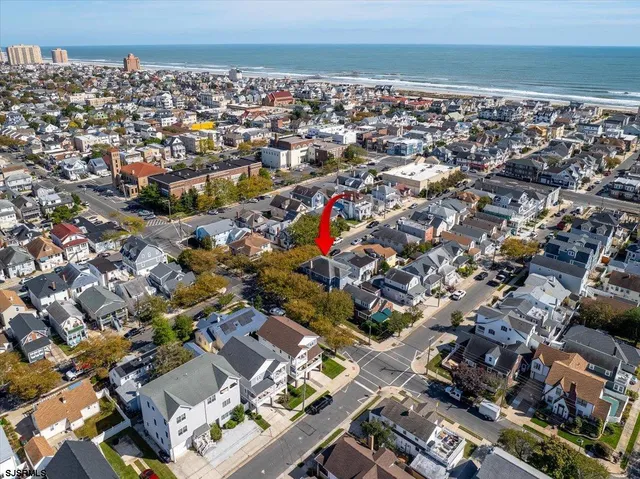 an aerial view of residential houses with city view