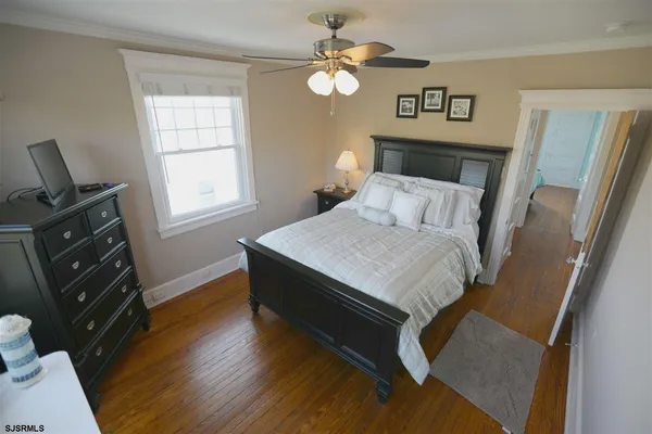 a bedroom with a bed dresser and a window