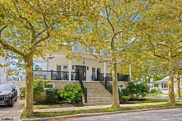front view of a house with a tree