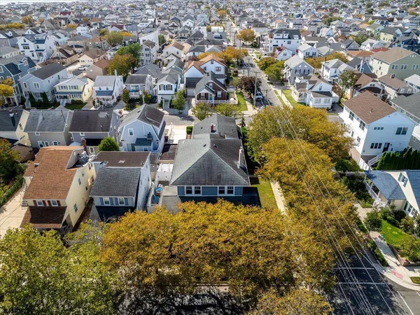 an aerial view of a house with a garden and lake view