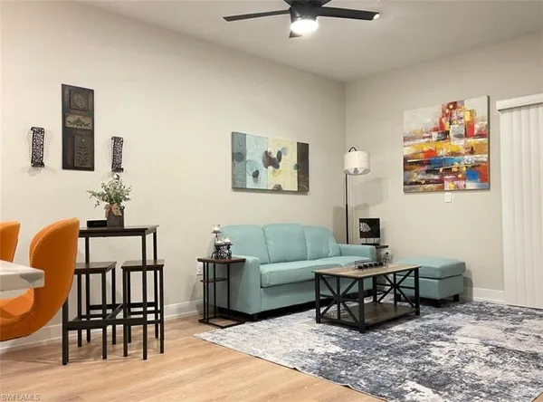 a living room with furniture and wooden floor
