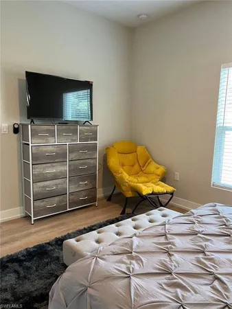 a bedroom with a bed and a television
