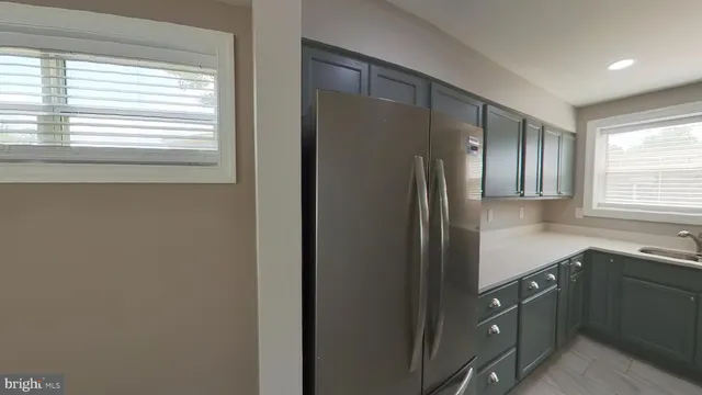 a kitchen with a refrigerator and a sink