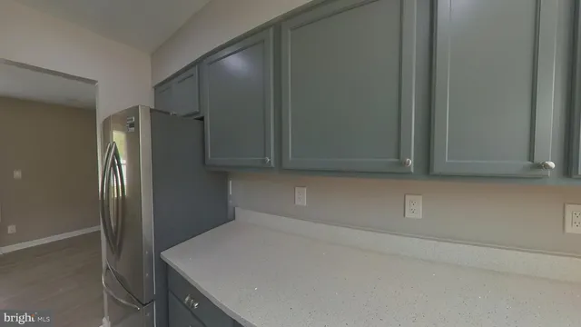 a room with a refrigerator and cabinets