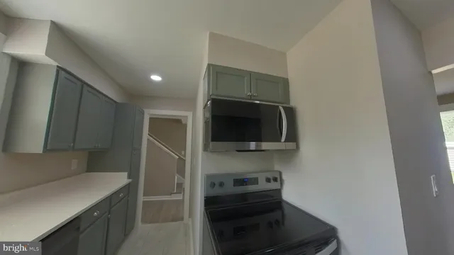 a kitchen with a sink and a stove top oven