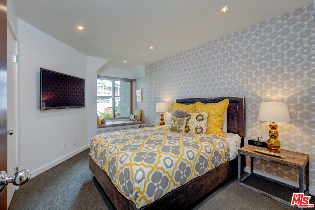 3544 Sunset Lane Oxnard, CA 93035 - Photo 27 of 56 a bedroom with a bed and a flat screen tv