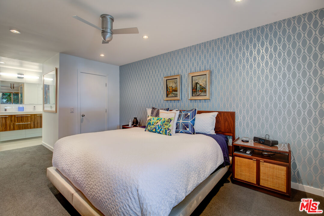 3544 Sunset Lane Oxnard, CA 93035 - Photo 36 of 56 a spacious bedroom with a bed and a chandelier