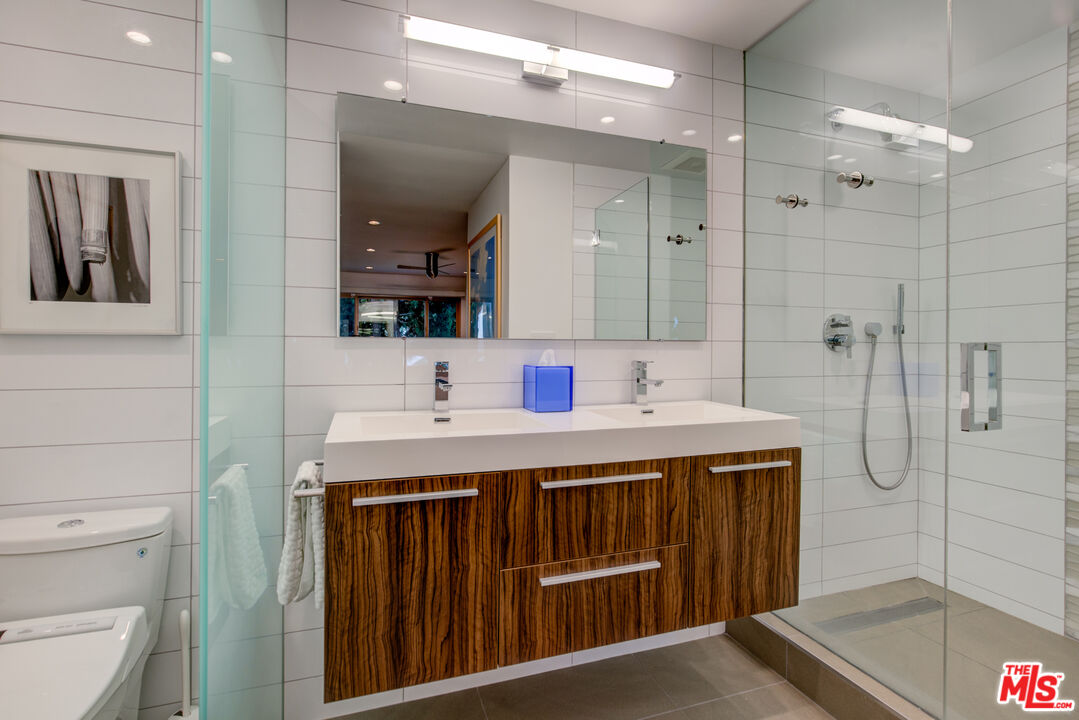 3544 Sunset Lane Oxnard, CA 93035 - Photo 39 of 56 a bathroom with a sink a toilet a mirror and shower