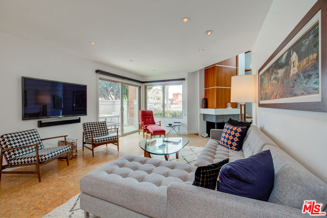 3544 Sunset Lane Oxnard, CA 93035 - Photo 5 of 56 a living room with furniture a flat screen tv and a floor to ceiling window