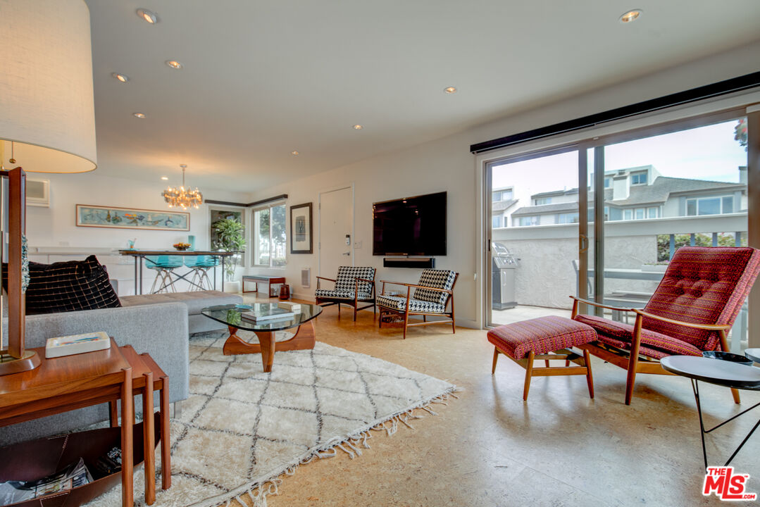 3544 Sunset Lane Oxnard, CA 93035 - Photo 9 of 56 a living room with furniture a flat screen tv and floor to ceiling window