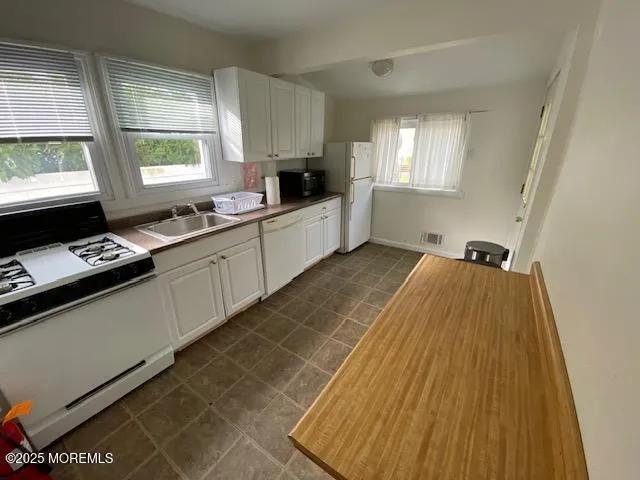 a kitchen with a sink a window and appliances