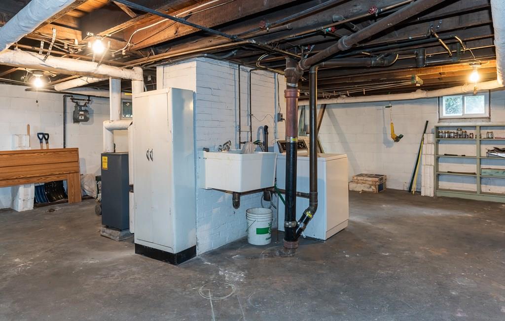 38 Castle Street Springfield, MA 01118 - Photo 38 of 41 a view of a storage room with water heater and racks