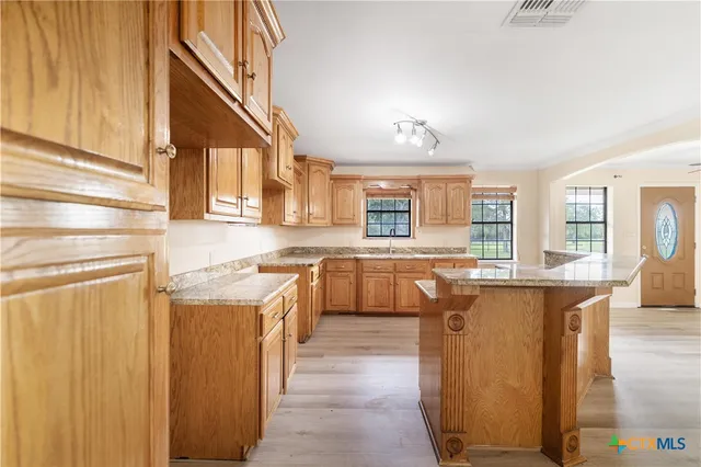 a kitchen with cabinets and window