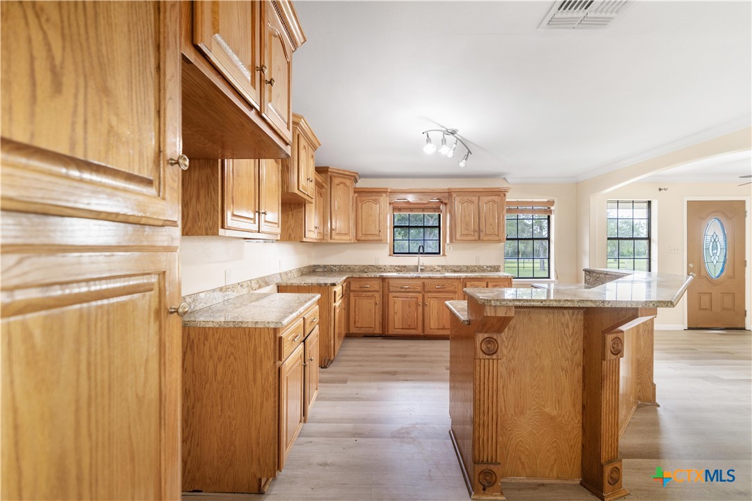 1033 Farm To Market 1351 Goliad, TX 77963 - Photo 11 of 34 a kitchen with cabinets and window