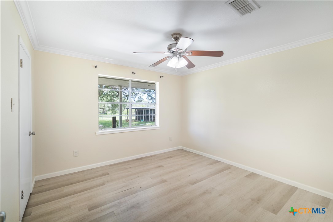 1033 Farm To Market 1351 Goliad, TX 77963 - Photo 14 of 34 an empty room with a window and a fan