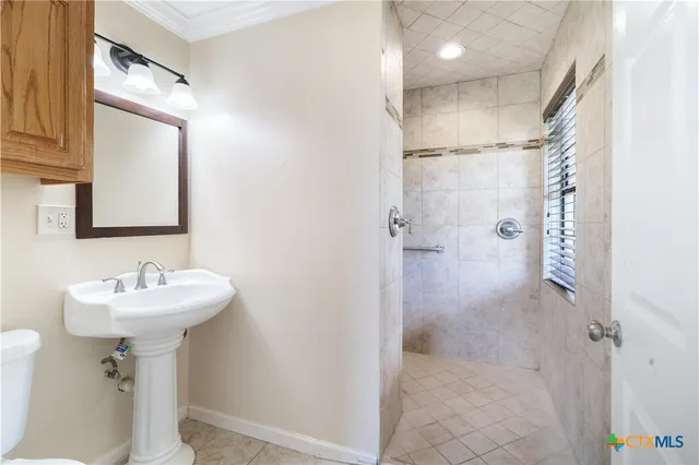 a bathroom with a sink mirror and shower