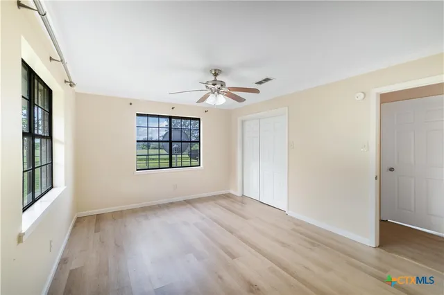 wooden floor in an empty room with a window