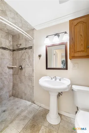 a bathroom with a sink toilet and shower
