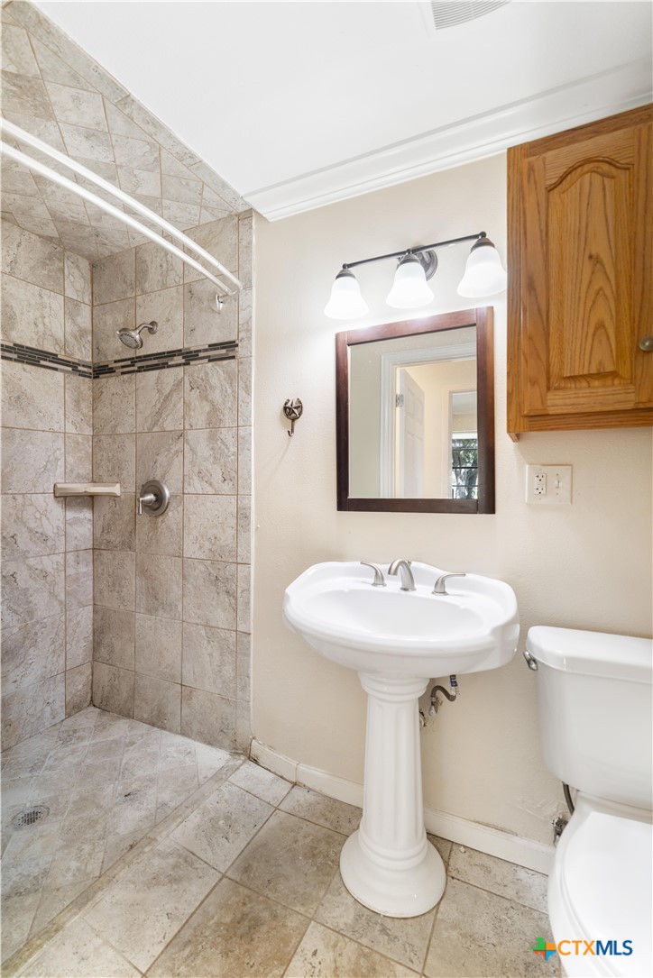 1033 Farm To Market 1351 Goliad, TX 77963 - Photo 18 of 34 a bathroom with a sink toilet and shower