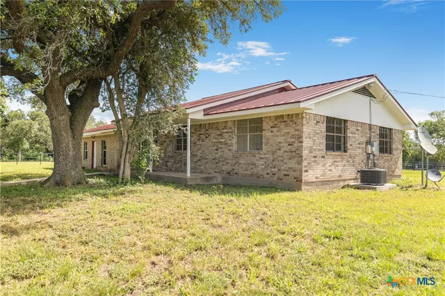 a view of a house with a yard and swimming pool