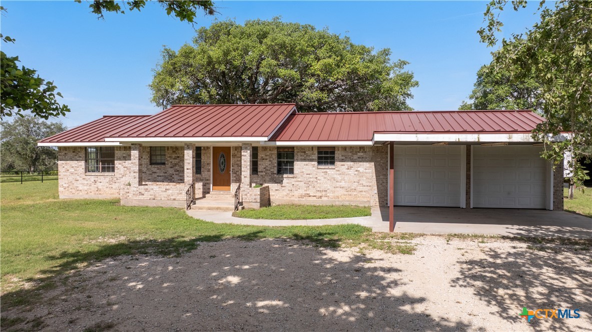 1033 Farm To Market 1351 Goliad, TX 77963 - Photo 7 of 34 a front view of a house with garden