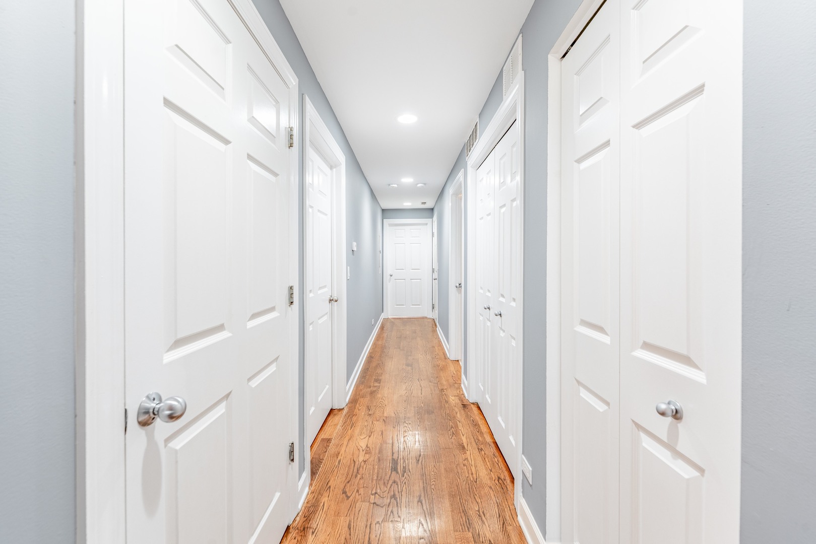 4011 West Fullerton Avenue, Unit 2E Chicago, IL 60639 - Photo 12 of 32 a view of a hallway with wooden floor and staircase