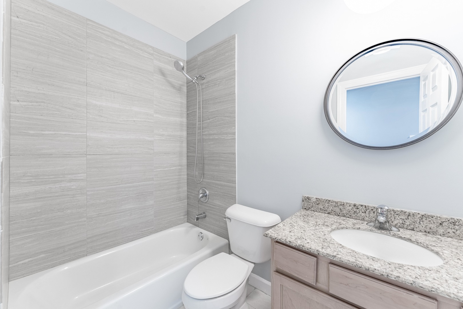 4011 West Fullerton Avenue, Unit 2E Chicago, IL 60639 - Photo 16 of 32 a bathroom with a granite countertop sink mirror toilet and bathtub