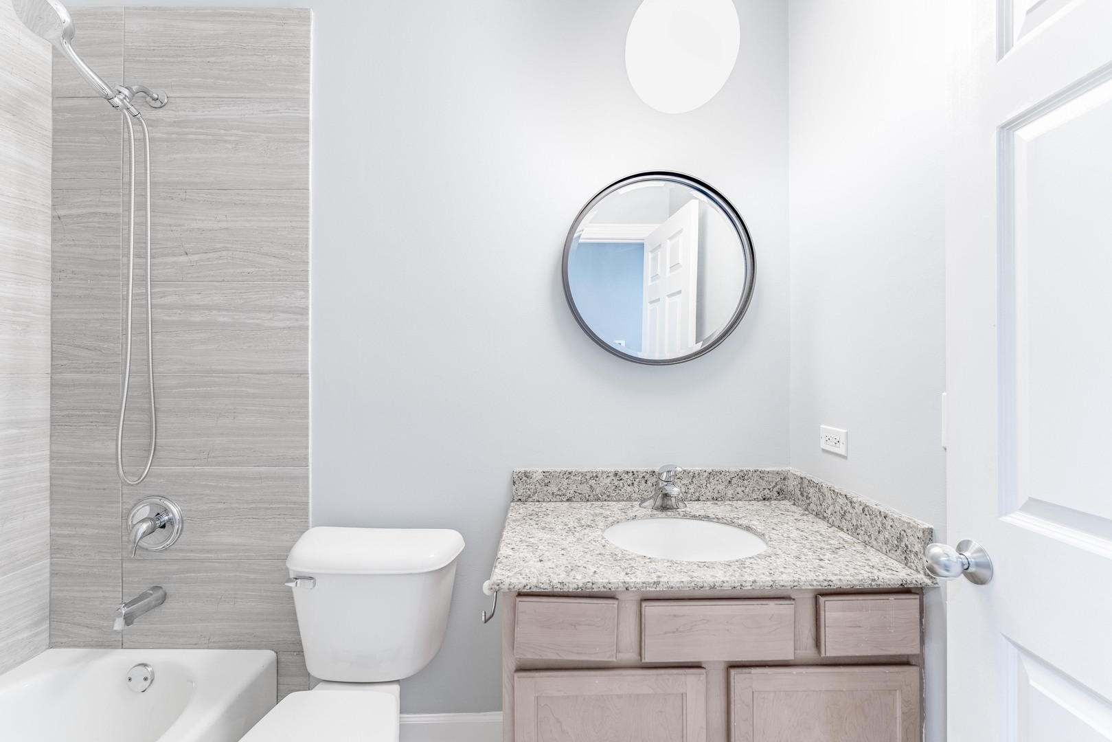 4011 West Fullerton Avenue, Unit 2E Chicago, IL 60639 - Photo 17 of 32 a bathroom with a granite countertop sink a toilet and a mirror