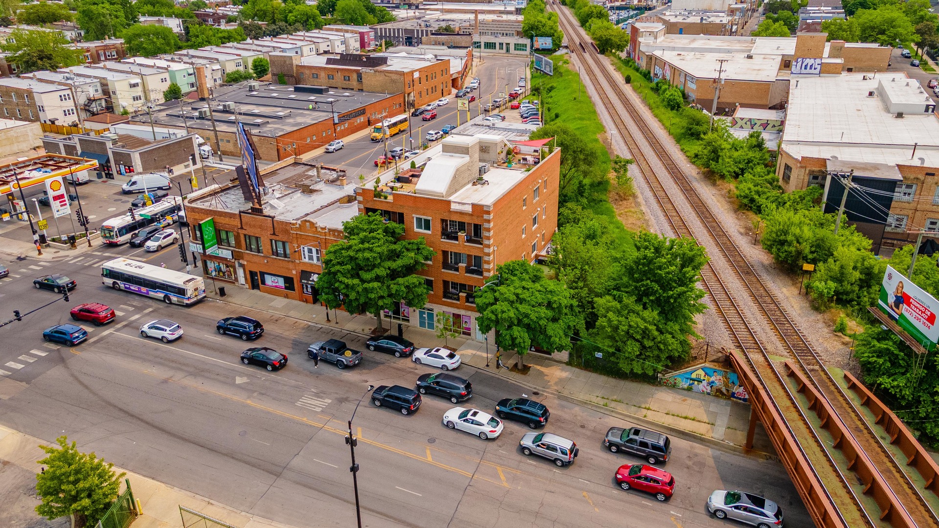 4011 West Fullerton Avenue, Unit 2E Chicago, IL 60639 - Photo 2 of 32 an aerial view of residential houses with outdoor space