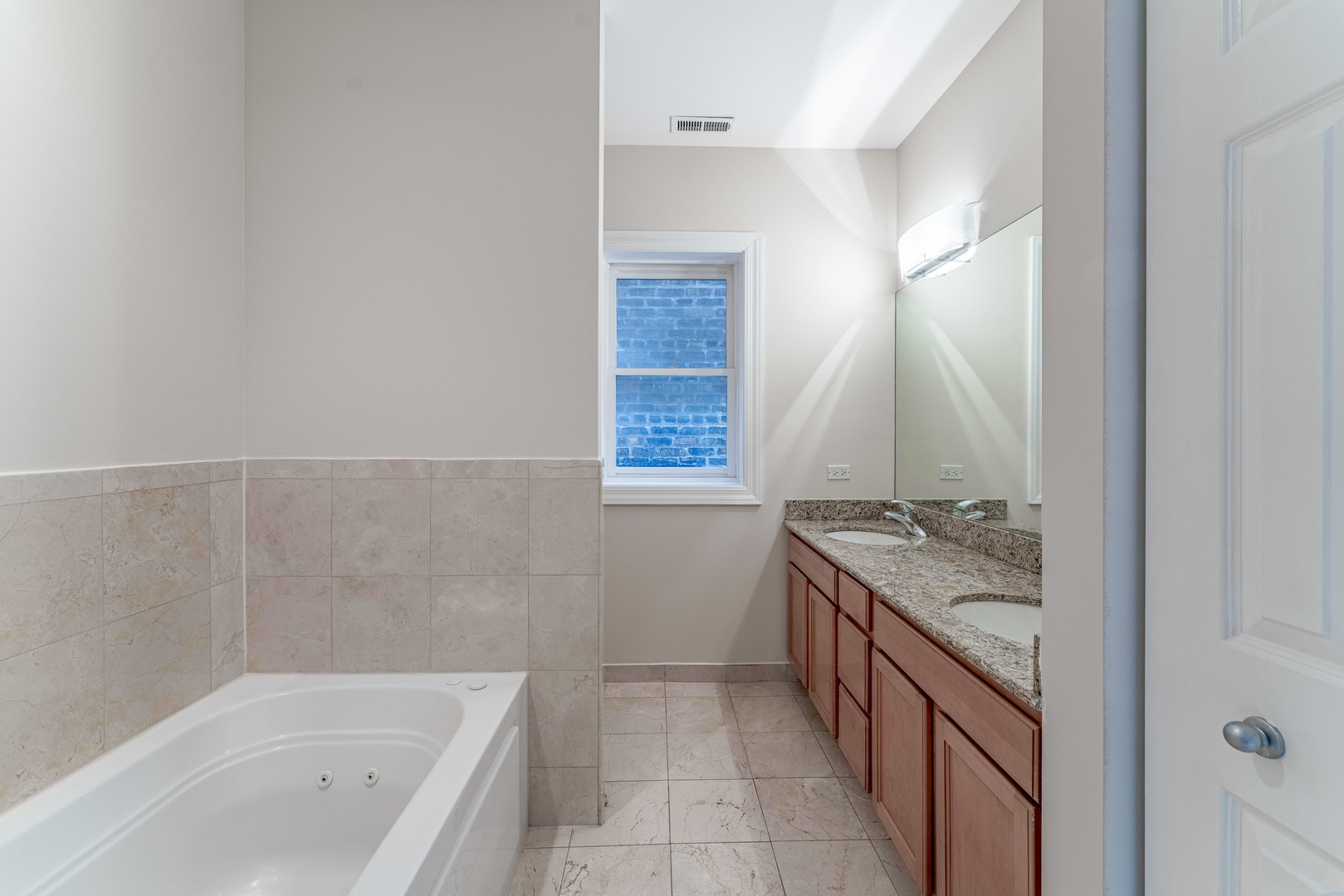 4011 West Fullerton Avenue, Unit 2E Chicago, IL 60639 - Photo 22 of 32 a bathroom with a granite countertop sink and a bathtub
