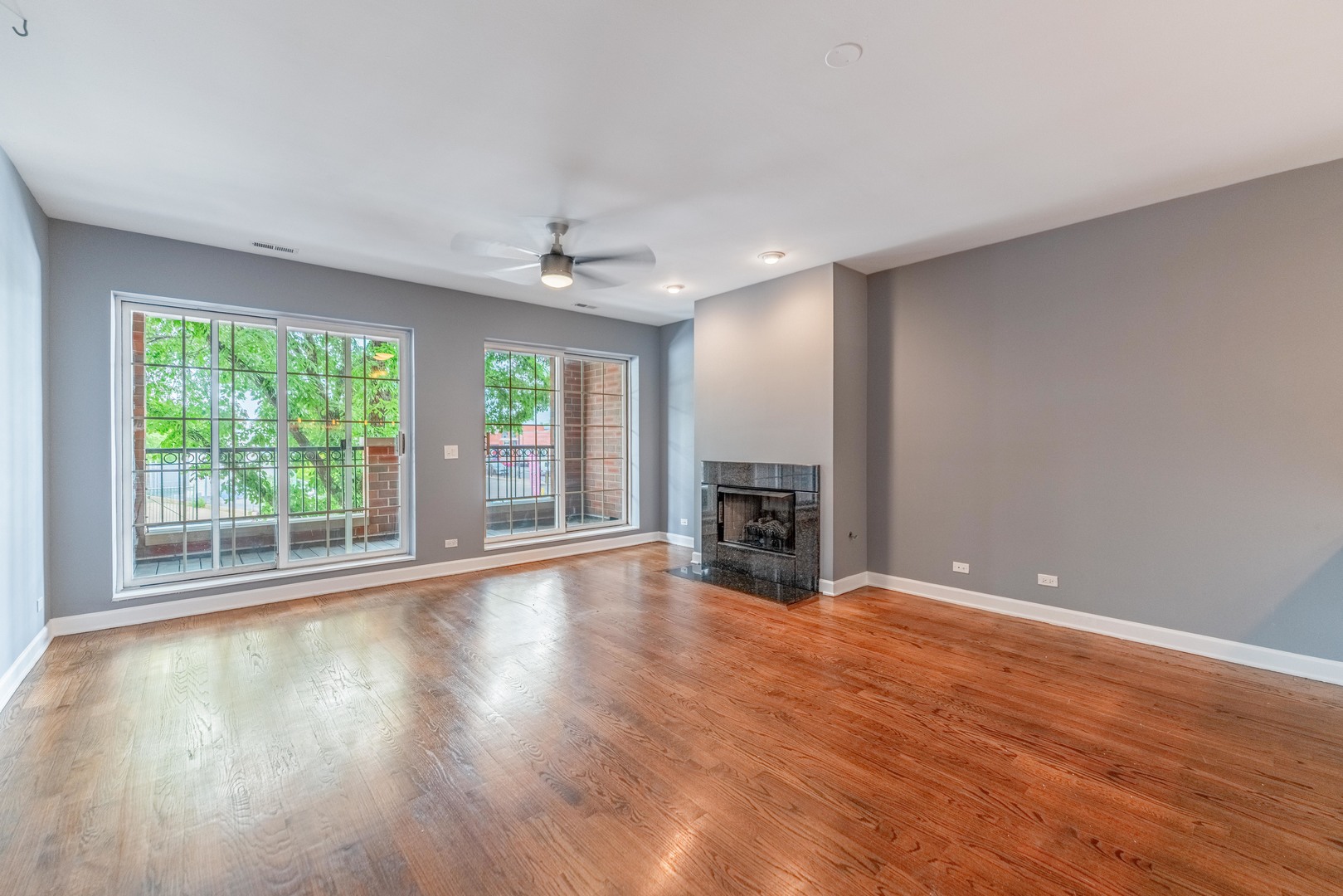 4011 West Fullerton Avenue, Unit 2E Chicago, IL 60639 - Photo 4 of 32 a view of an empty room with wooden floor and a window