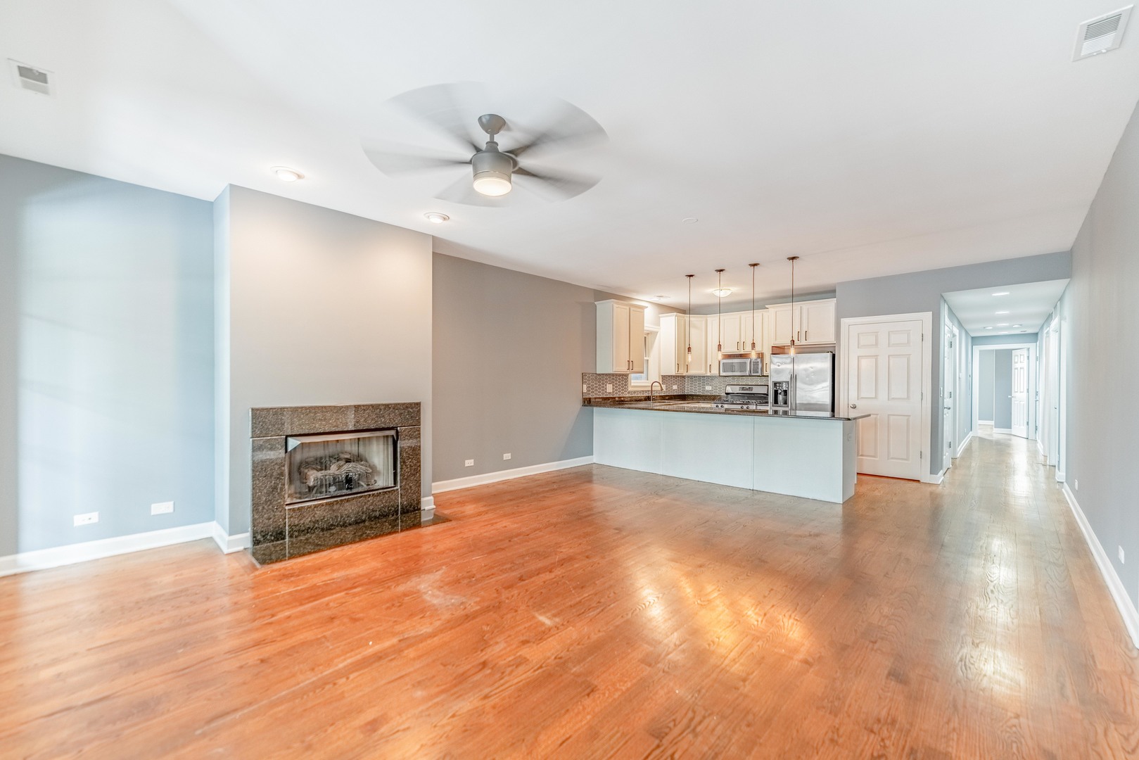 4011 West Fullerton Avenue, Unit 2E Chicago, IL 60639 - Photo 5 of 32 a view of a kitchen with a sink and a fireplace