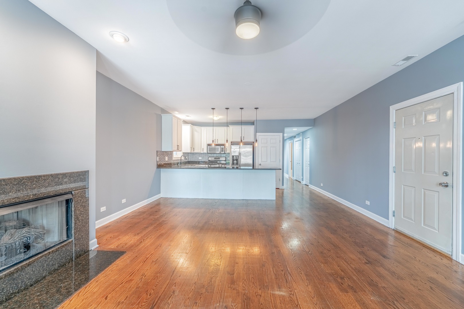 4011 West Fullerton Avenue, Unit 2E Chicago, IL 60639 - Photo 7 of 32 a view of a kitchen with wooden floor and a kitchen